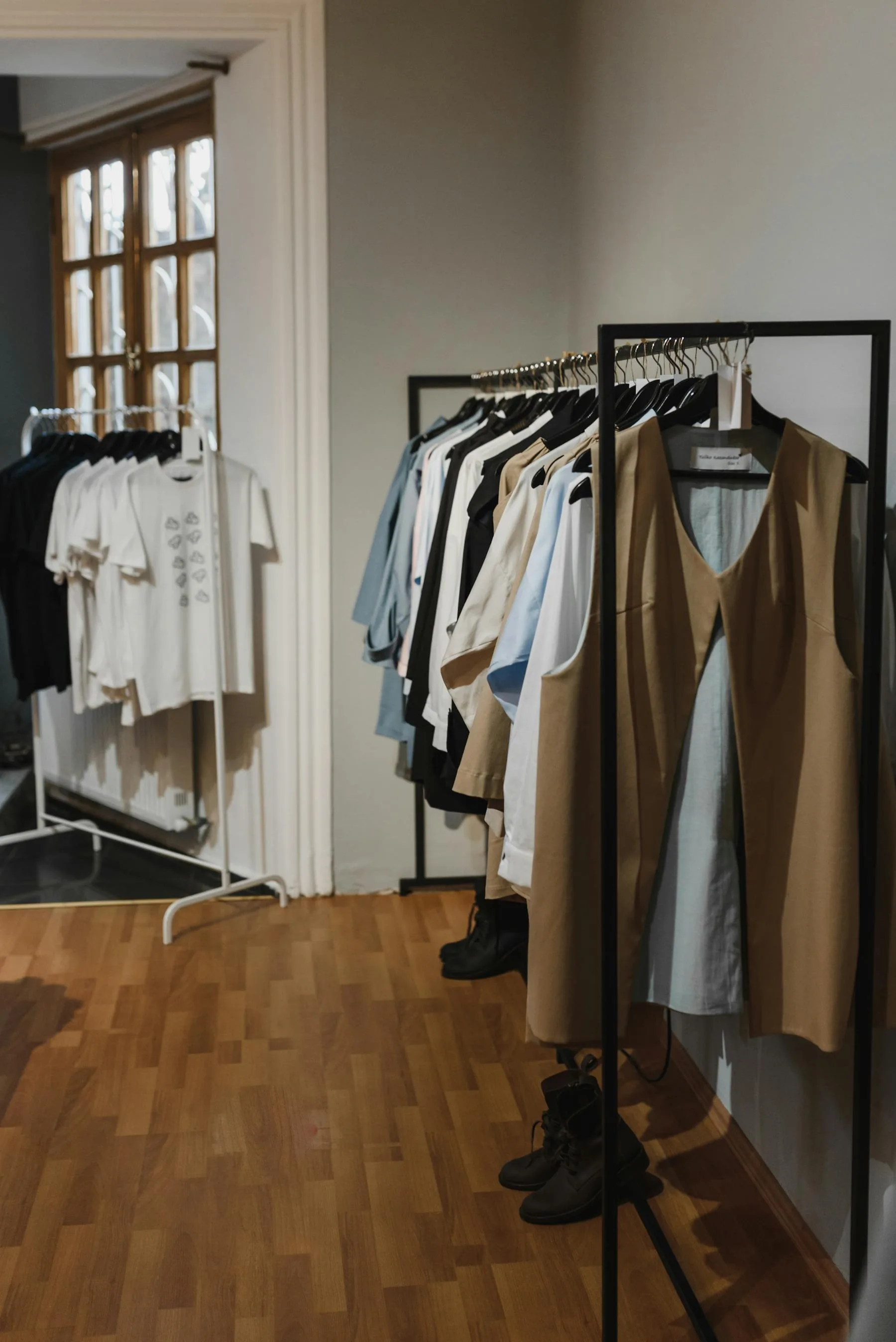 A polished boutique interior with organized clothing racks